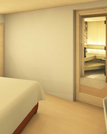 Schlafzimmer mit Doppelbett und freistehender Badewanne vor einem großen Fenster.