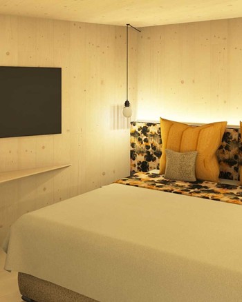 Schlafzimmer mit Fernseher und Doppelbett mit gelben Farbakzenten.